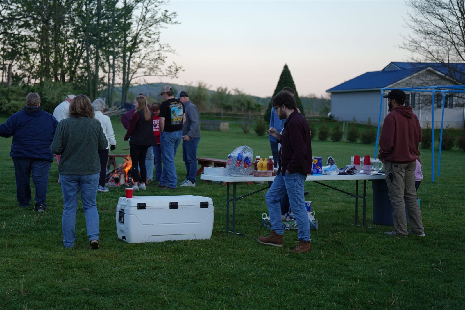 Gathering around the fire for food and fellowship in the evening
