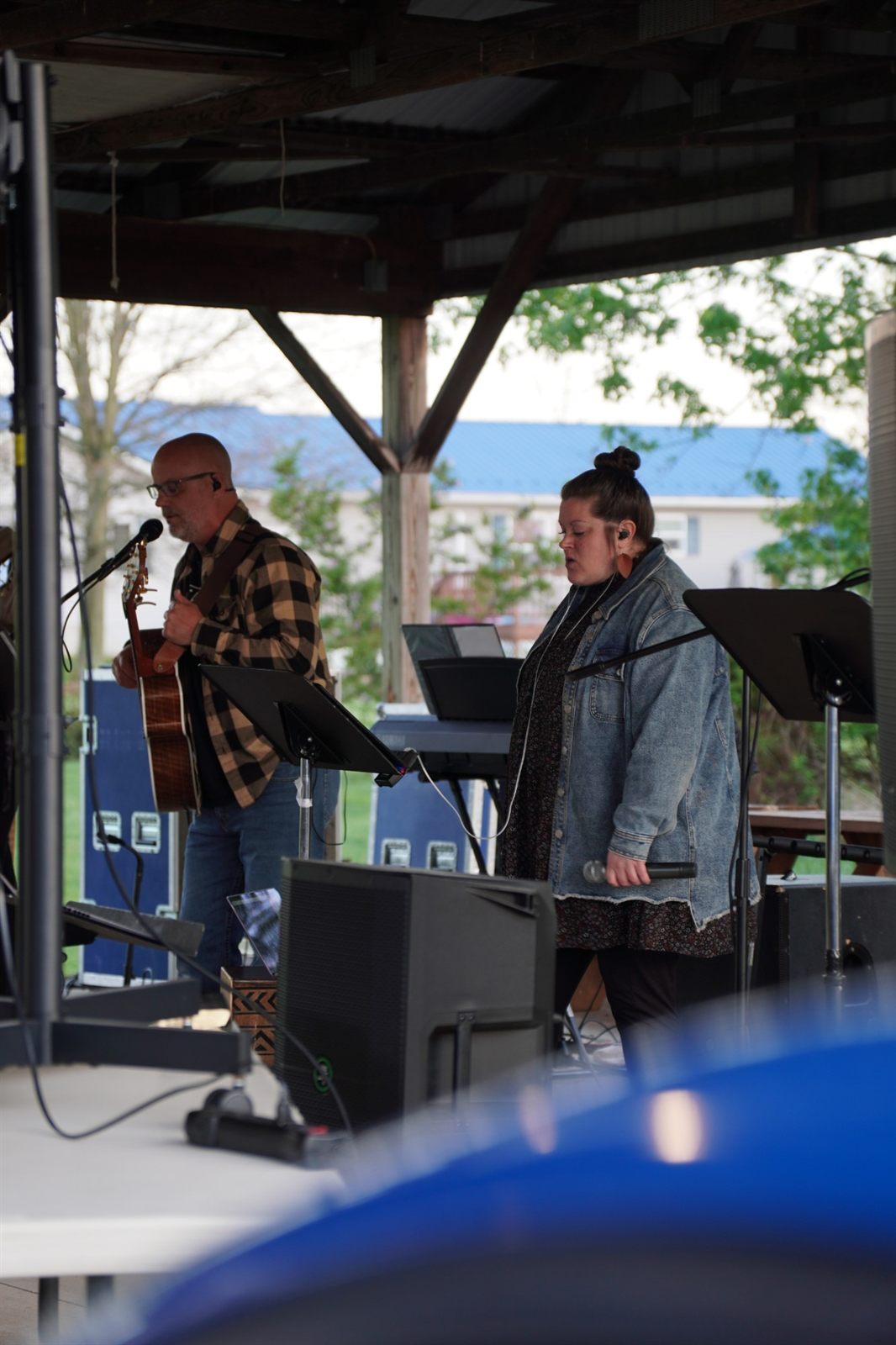 Worship leaders leading a song on the outdoor stage
