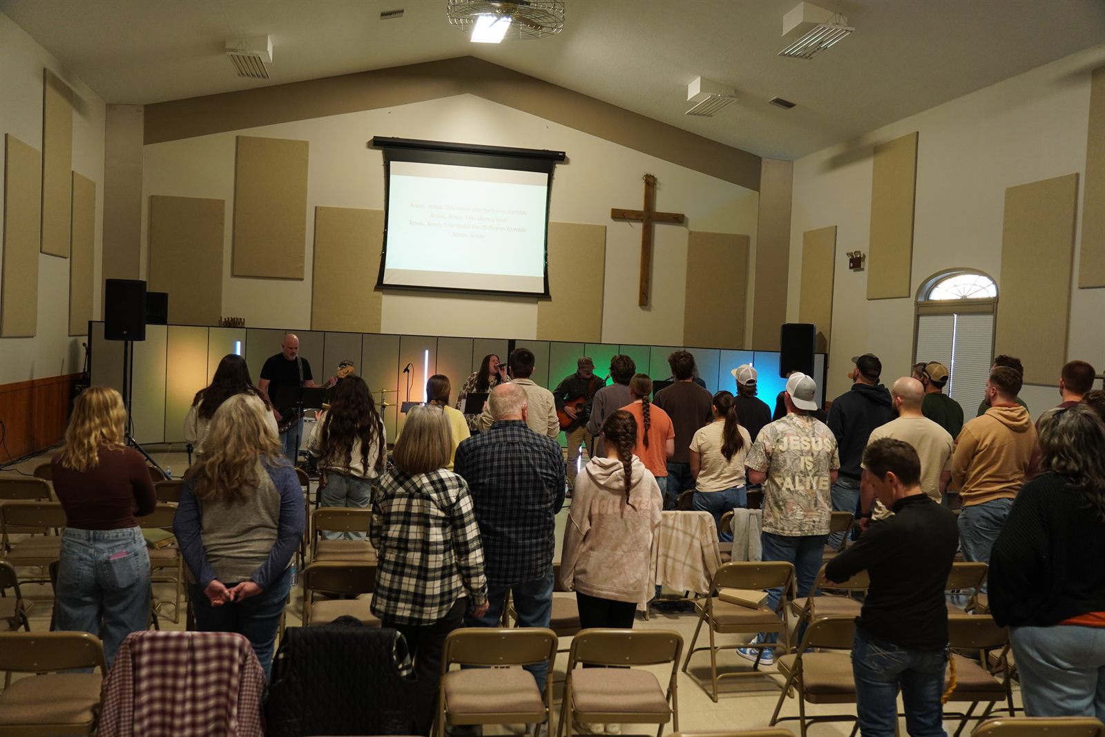The room gathered beneath a cross